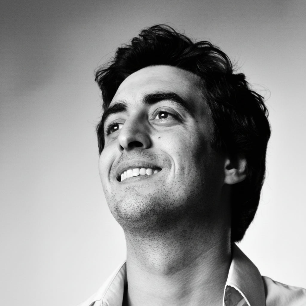 Black and white portrait of a man smiling against a gradient background