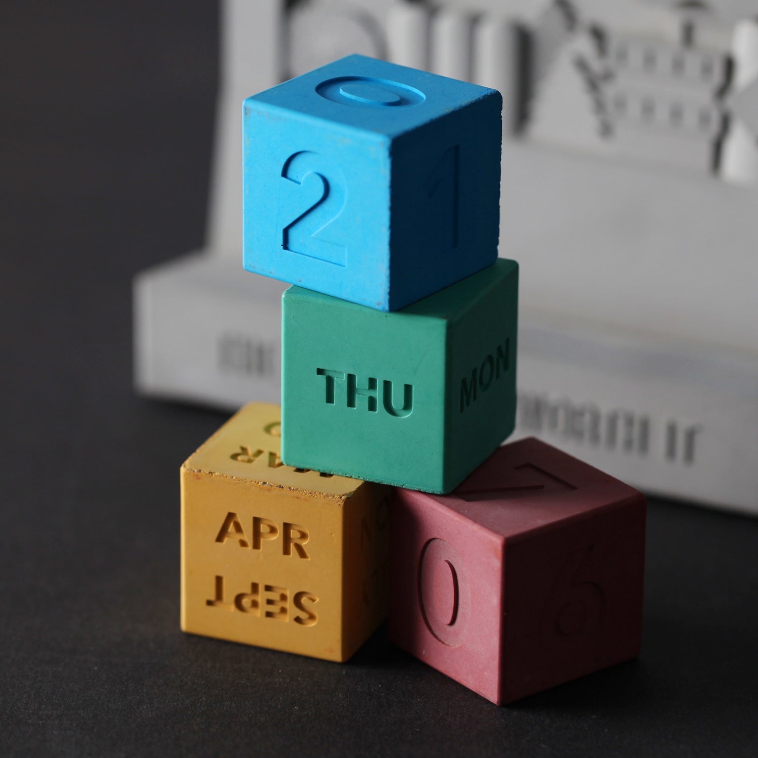Concrete calendar designed and manufactured by 22STUDIO as a bespoke corporate gift. Featuring colorful, stackable cubes for days, months, and dates, this tactile and modular piece blends playful design with premium craftsmanship—ideal for branded giveaways, deal toys, or finance tombstones with a creative twist.